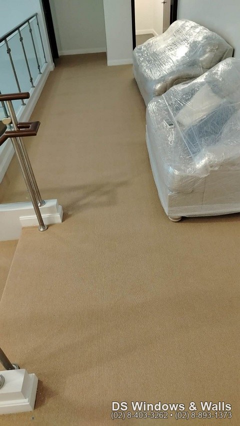 carpet roll covering a landing and living area in a Mandaluyong home