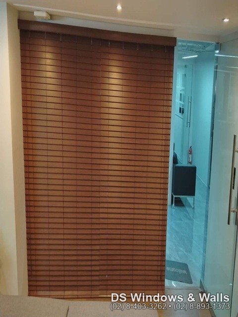 dark wood tone faux wood blinds beside glass door, Quezon City installation